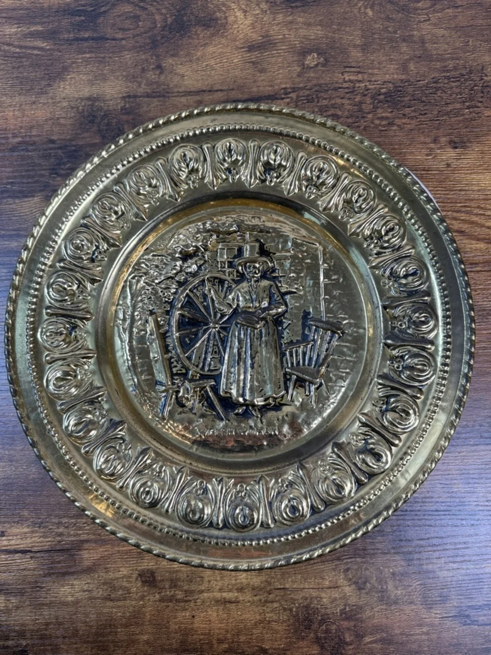 Decorative Embossed Brass Wall Plate with Spinning Wheel Motif